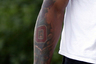 In this photo taken Monday, May 30, 2011, a tattoo is seen on the arm of Ohio State quarterback Terrelle Pryor as he arrives for a players only meeting at the Woody Hayes Complex in Columbus, Ohio. Pryor, the highest profile recruit of former coach Jim Tressel's 25-year coaching career, is one of five Buckeyes who have already been suspended for the first five games of the 2011 season for taking money and tattoos from local tattoo-parlor owner Edward Rife, who pleaded guilty last week to federal drug trafficking and money-laundering charges. (AP Photo/Terry Gilliam)
