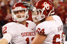 ARLINGTON TX - DECEMBER 04:  Quarterback Landry Jones #12 of the Oklahoma Sooners celebrates with guard Gabe Ikard #64 after Jones scored against the Nebraska Cornhuskers at Cowboys Stadium on December 4 2010 in Arlington Texas.  (Photo by Tom Pennington/Getty Images)