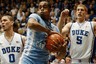 Mar 3, 2012; Durham, NC, USA; North Carolina Tar Heels forward John Henson (31) pulls down a rebound in front of Duke Blue Devils forward Mason Plumlee (5) and guard Austin Rivers (0) during the first half at Cameron Indoor Stadium. Mandatory Credit: Mark Dolejs-US PRESSWIRE