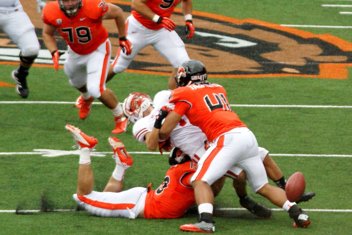 Oregon St.'s Feti Taumoepeau puts a stop to Wisconsin's Jared Abbrederis' crossing routes. <em>(Photo by Andy Wooldridge)</em>